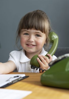 portrait-cute-girl-talking-rotary-phone-office